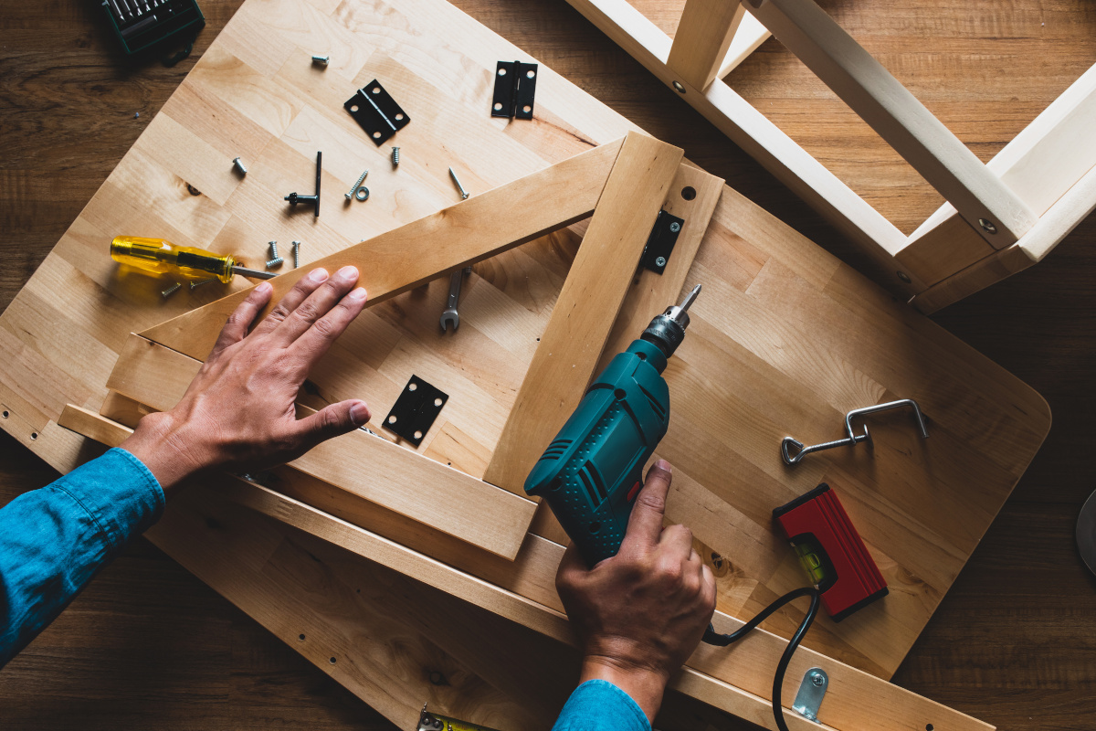 Carpenter man working  with drill and furniture,fixing or repairing house.modern living concepts ideas