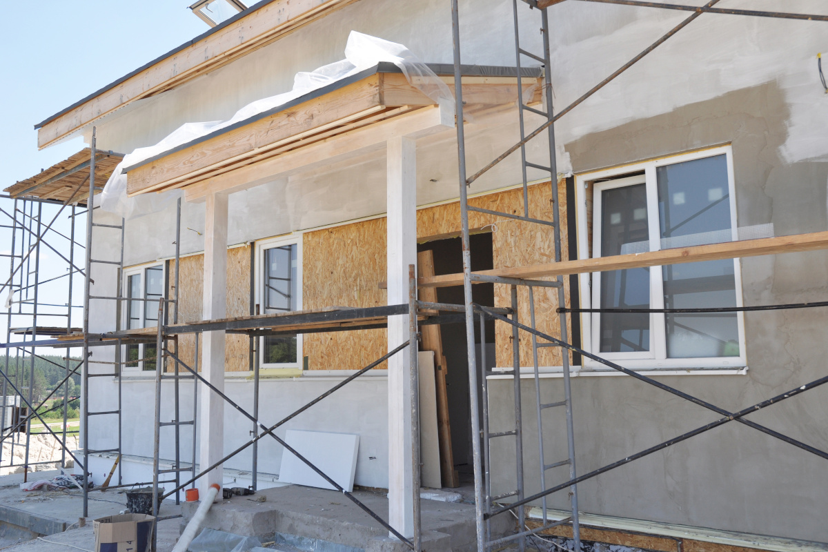 House renovation with plastering and painting walls. Renovate and insulate modern house with insulation and painting.